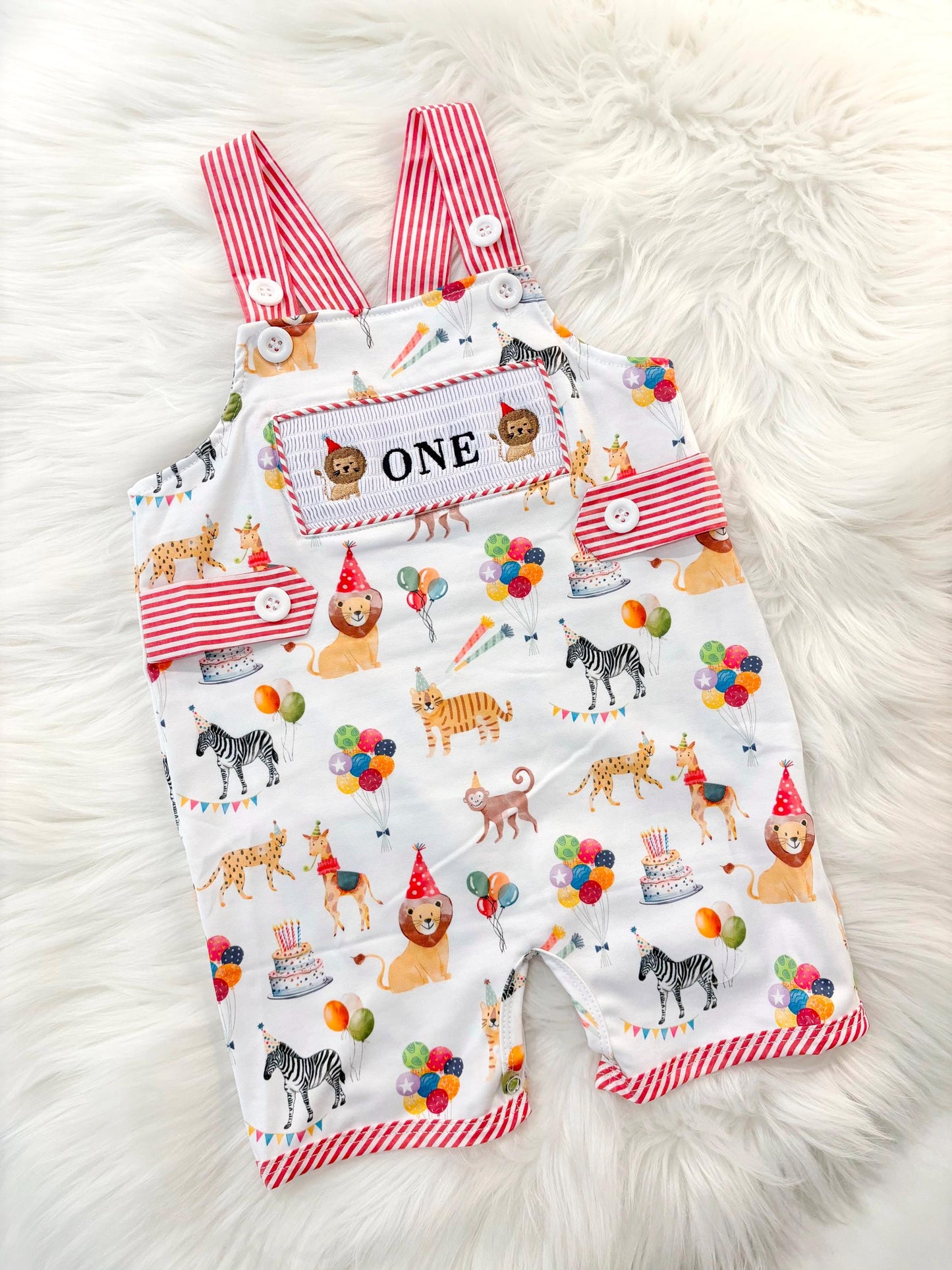 carnival circus party animal cake smash outfit first birthday boy romper 1st birthday red  and white striped stripes colorful smash cake outfit overalls, ONE smocked romper first birthday, animals lion embroidered smocked spring summer 1st birthday boy outfit romper baby boys cake smash outfit, the mod mango baby boutique co