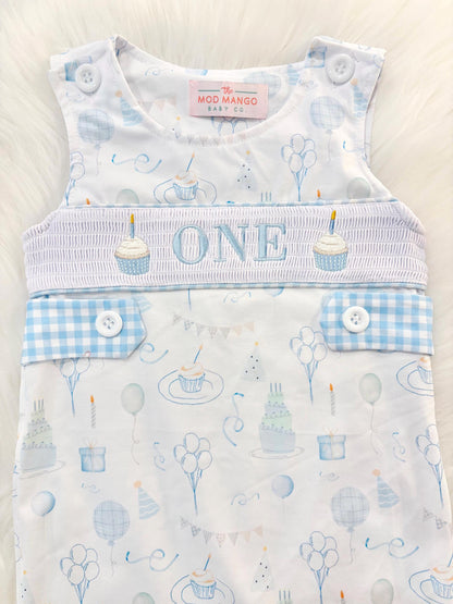blue and white gingham checkered first birthday cupcakes romper pants outfit, one is fun first birthday outfit, it's fun to be one first birthday boy romper blue green longtalls blue white gingham smash cake outfit overalls, ONE smocked romper first birthday party hats, balloons embroidered smocked spring summer fall 1st birthday boy outfit romper baby boys 1st birthday cake smash outfit, the mod mango baby boutique co, boys first birthday outfit theme