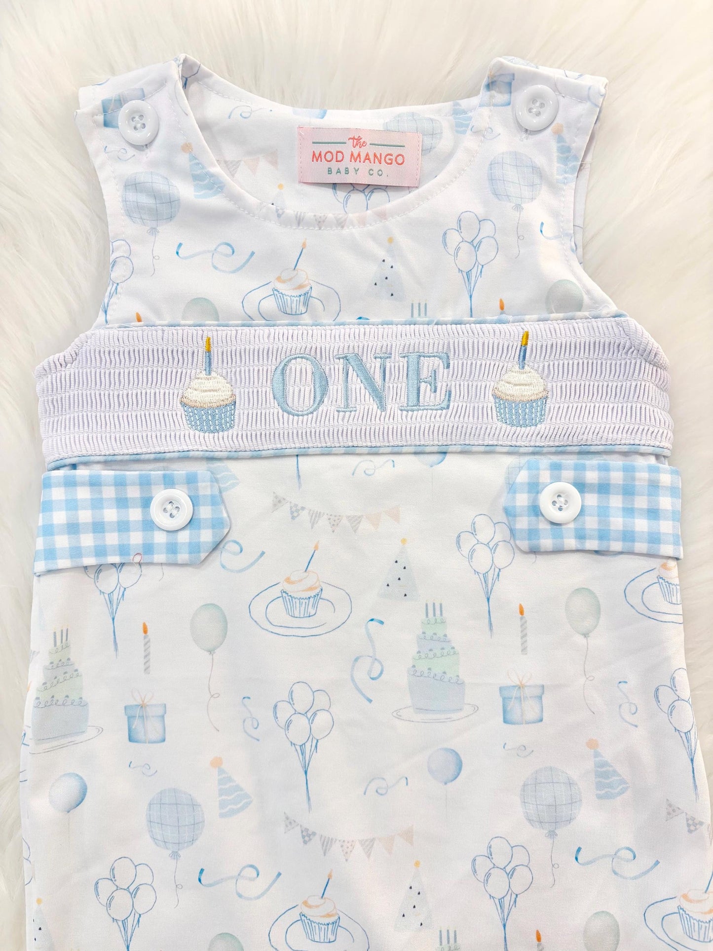 blue and white gingham checkered first birthday cupcakes romper pants outfit, one is fun first birthday outfit, it's fun to be one first birthday boy romper blue green longtalls blue white gingham smash cake outfit overalls, ONE smocked romper first birthday party hats, balloons embroidered smocked spring summer fall 1st birthday boy outfit romper baby boys 1st birthday cake smash outfit, the mod mango baby boutique co, boys first birthday outfit theme