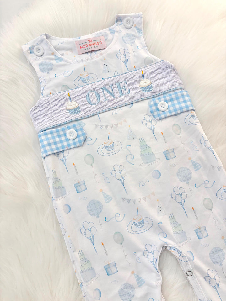 blue and white gingham checkered first birthday romper pants outfit, one is fun first birthday outfit, it&#39;s fun to be one first birthday boy romper blue green longtalls blue white gingham smash cake outfit overalls, ONE smocked romper first birthday party hats, balloons embroidered smocked spring summer fall 1st birthday boy outfit romper baby boys 1st birthday cake smash outfit, the mod mango baby boutique co, boys first birthday outfit theme
