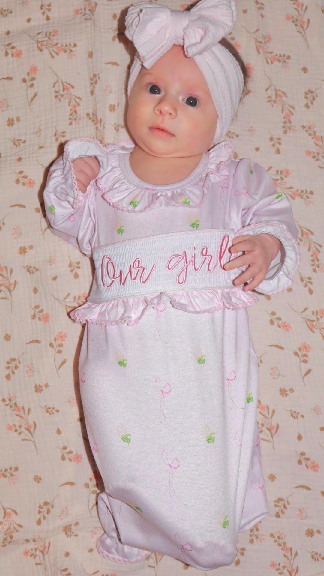newborn girls pink and white baby gown with flowers and bows coquette for baby girl, our girl monogram baby shower gift for girl, light pink gingham baby gift, newborn coming home outfit, baby shower gift set, pregnancy announcement, custom newborn baby gown, boutique smocked baby gift set, the mod mango baby boutique co