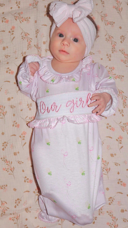 newborn girls pink and white baby gown with flowers and bows coquette for baby girl, our girl monogram baby shower gift for girl, light pink gingham baby gift, newborn coming home outfit, baby shower gift set, pregnancy announcement, custom newborn baby gown, boutique smocked baby gift set, the mod mango baby boutique co