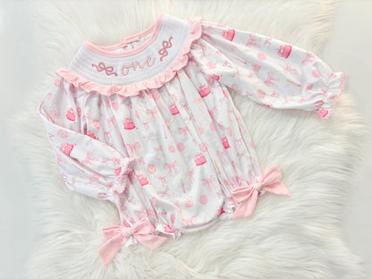pink bow first birthday girl romper pink and white outfit, pink white smocked bubble romper first birthday winter bows ruffle bows  embroidered smocked long sleeve 1st birthday outfit romper baby girls the mod mango baby boutique