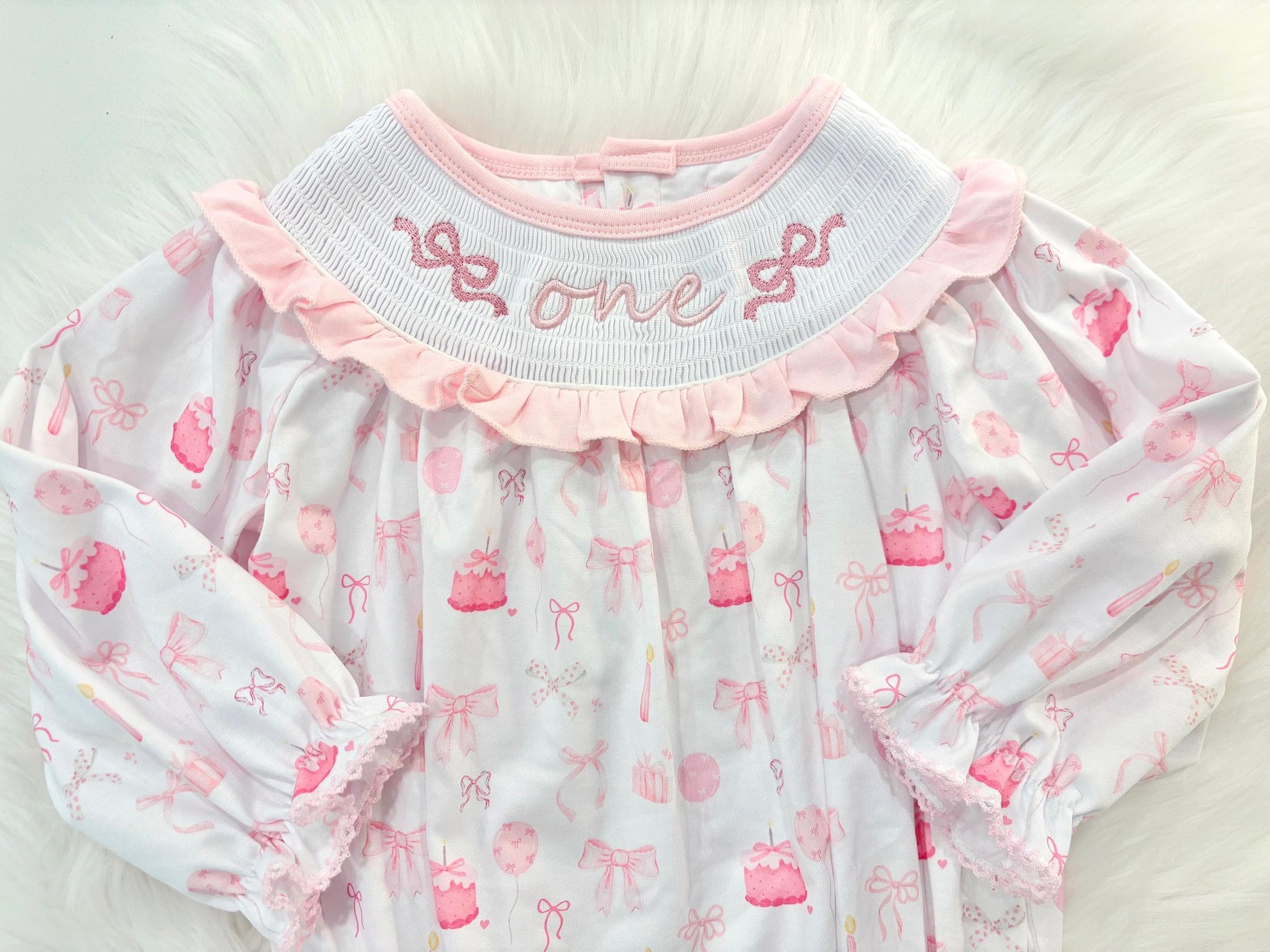 pink bow first birthday girl romper pink and white outfit, pink white smocked bubble romper first birthday winter bows ruffle bows  embroidered smocked long sleeve 1st birthday outfit romper baby girls the mod mango baby boutique
