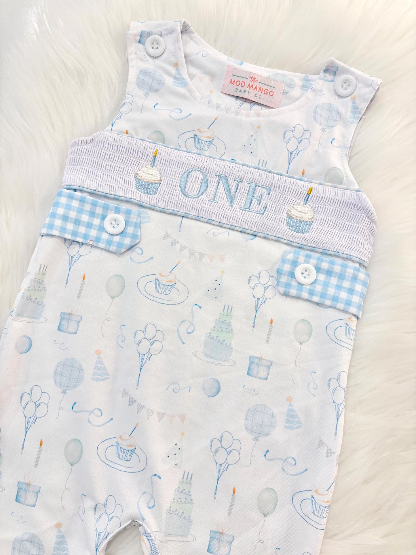 blue and white gingham checkered first birthday cupcakes romper pants outfit, one is fun first birthday outfit, it's fun to be one first birthday boy romper blue green longtalls blue white gingham smash cake outfit overalls, ONE smocked romper first birthday party hats, balloons embroidered smocked spring summer fall 1st birthday boy outfit romper baby boys 1st birthday cake smash outfit, the mod mango baby boutique co, boys first birthday outfit theme