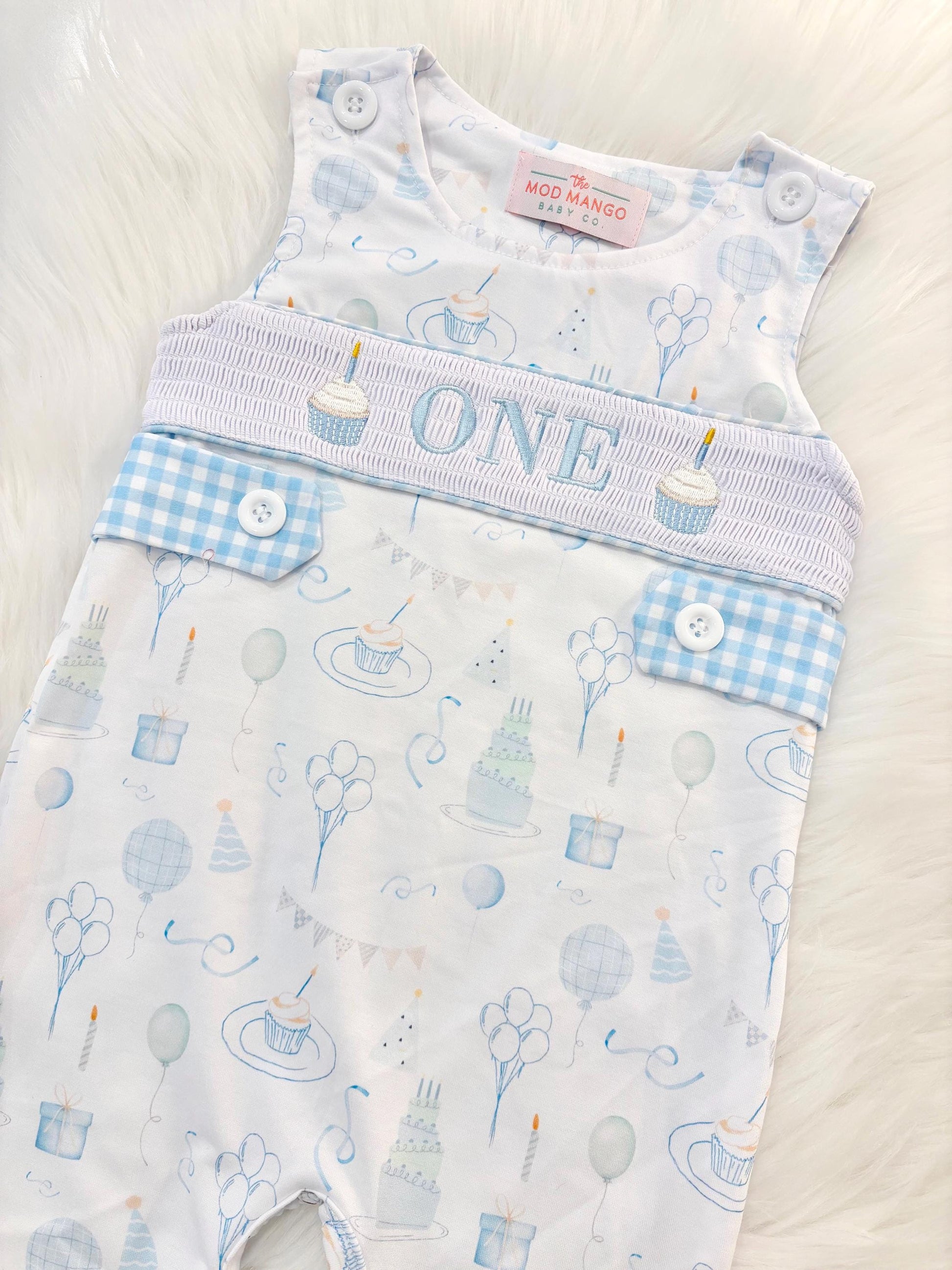 blue and white gingham checkered first birthday cupcakes romper pants outfit, one is fun first birthday outfit, it's fun to be one first birthday boy romper blue green longtalls blue white gingham smash cake outfit overalls, ONE smocked romper first birthday party hats, balloons embroidered smocked spring summer fall 1st birthday boy outfit romper baby boys 1st birthday cake smash outfit, the mod mango baby boutique co, boys first birthday outfit theme