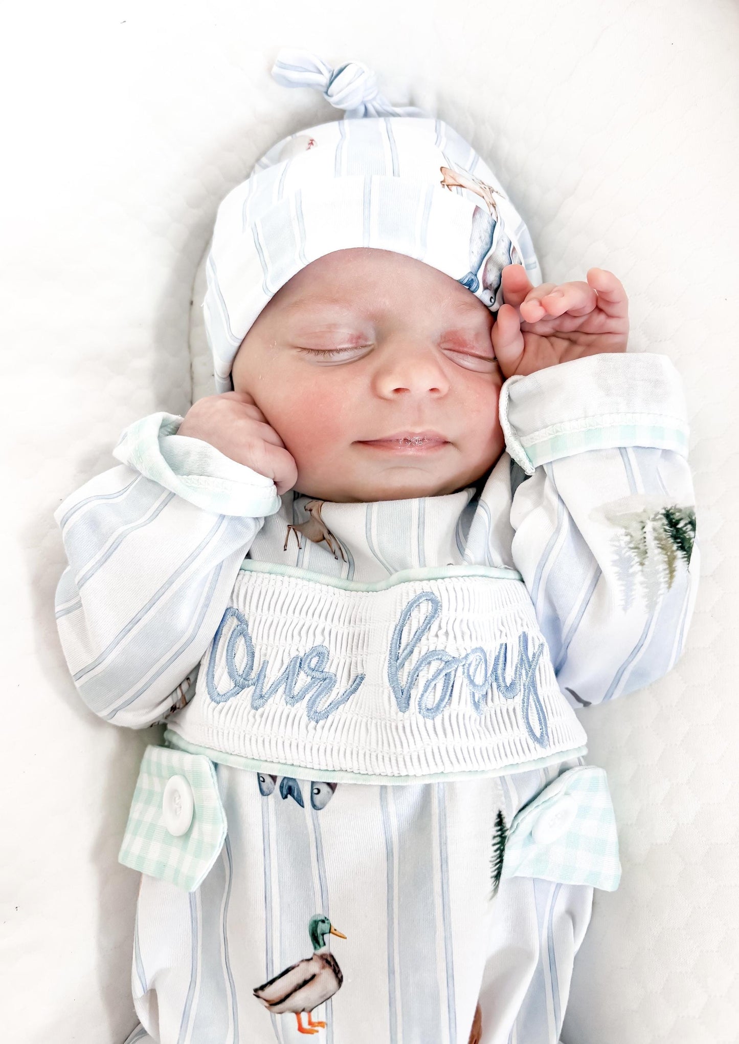 preppy newborn boys baby blue and white smocked baby romper outfit bodysuit and knotted hat with stripes and boy hunting for baby, fish buck deer bear football sports baseball mallard duck puppy dog pine trees outdoor all american boy, our boy monogram baby shower gift for boy, light blue and mint green gingham baby gift, newborn coming home outfit, baby shower gift set, pregnancy announcement, custom newborn baby romper outfit, boutique smocked baby gift set, the mod mango baby boutique co