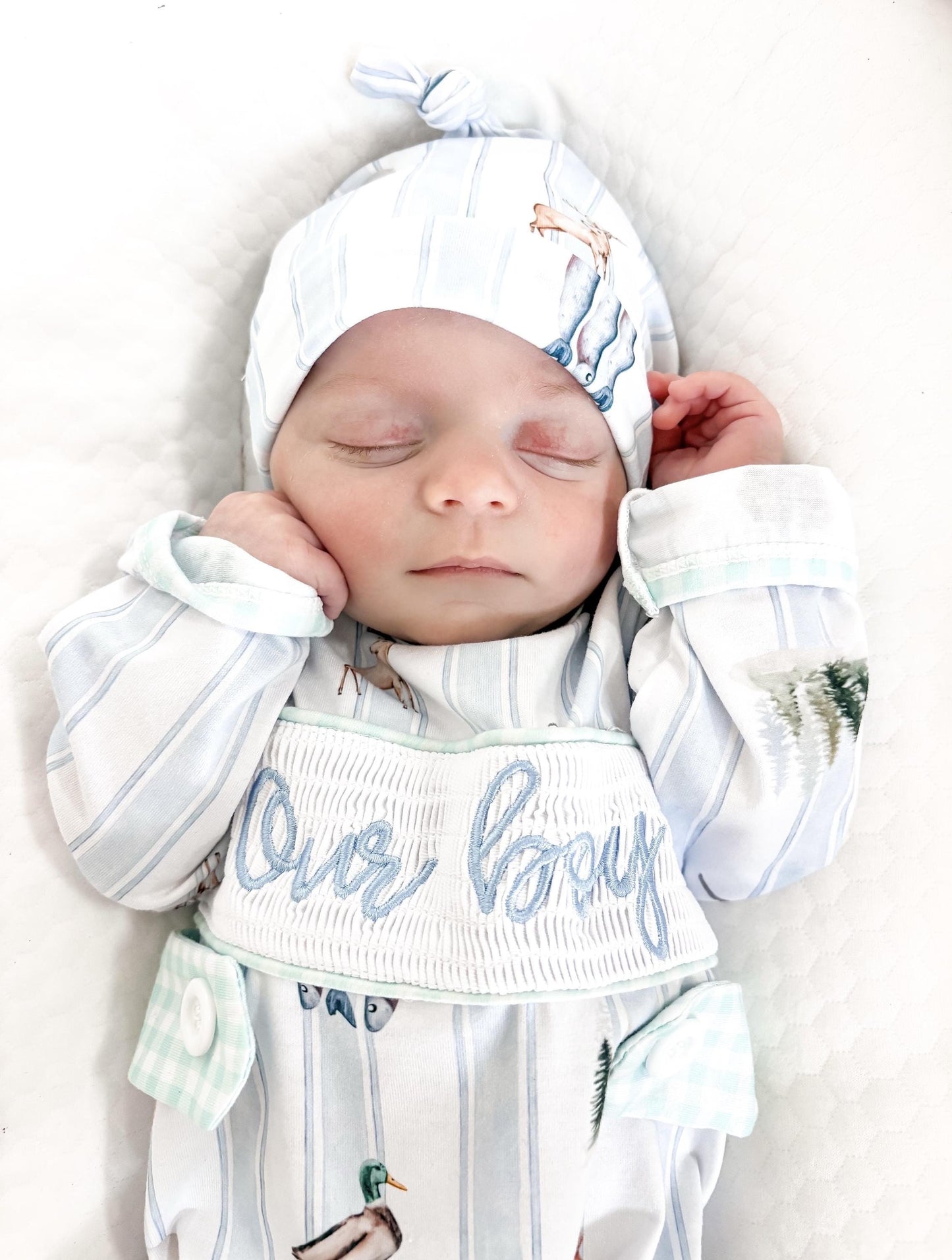 preppy newborn boys baby blue and white smocked baby romper outfit bodysuit and knotted hat with stripes and boy hunting for baby, fish buck deer bear football sports baseball mallard duck puppy dog pine trees outdoor all american boy, our boy monogram baby shower gift for boy, light blue and mint green gingham baby gift, newborn coming home outfit, baby shower gift set, pregnancy announcement, custom newborn baby romper outfit, boutique smocked baby gift set, the mod mango baby boutique co