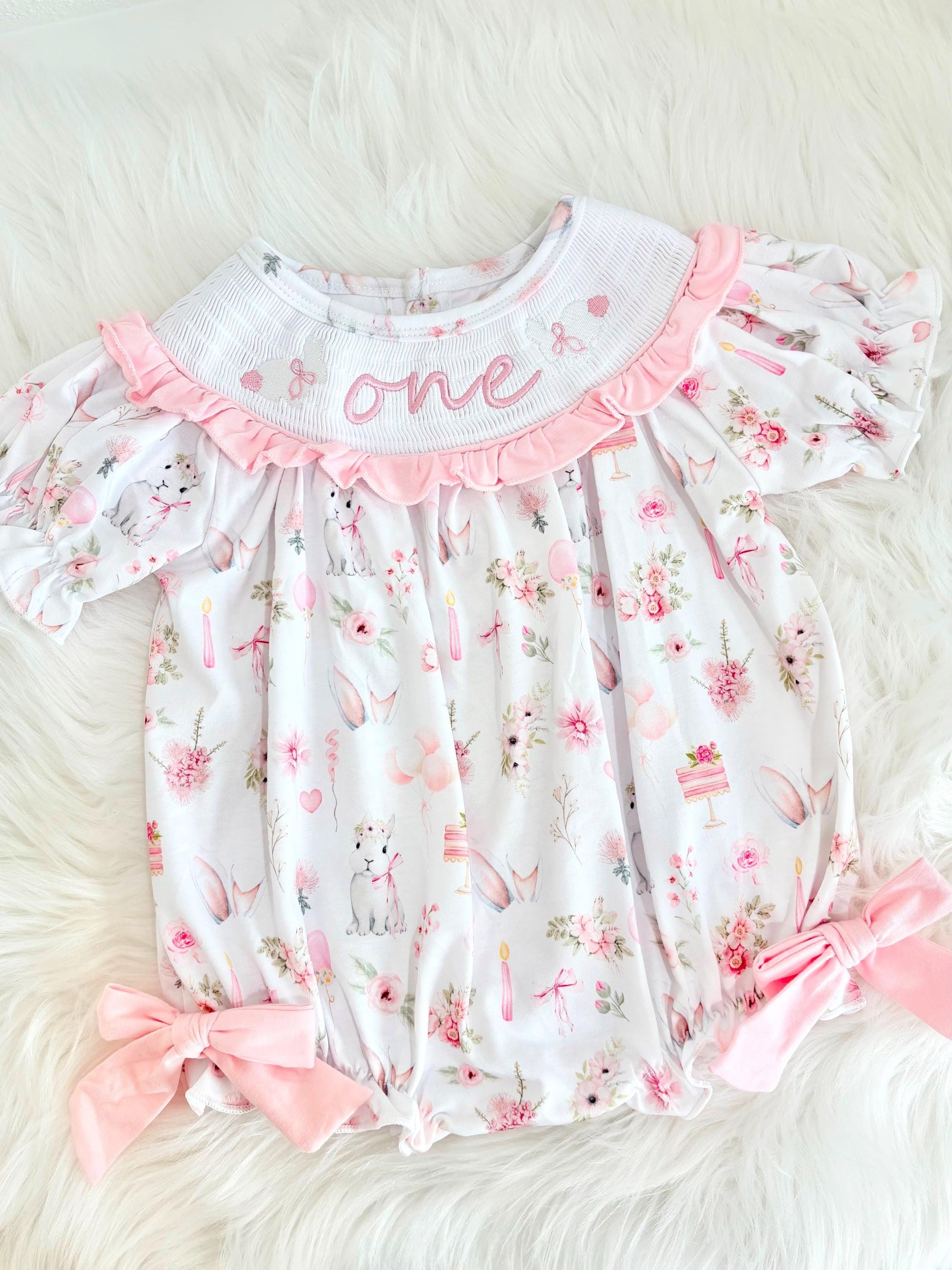 some bunny is one  pink bow first birthday girl romper pink and white outfit, girls one pink white smocked romper dress first birthday spring bunny rabbit easter bow ruffle embroidered smocked short sleeve 1st birthday outfit romper baby girls, the mod mango baby boutique co