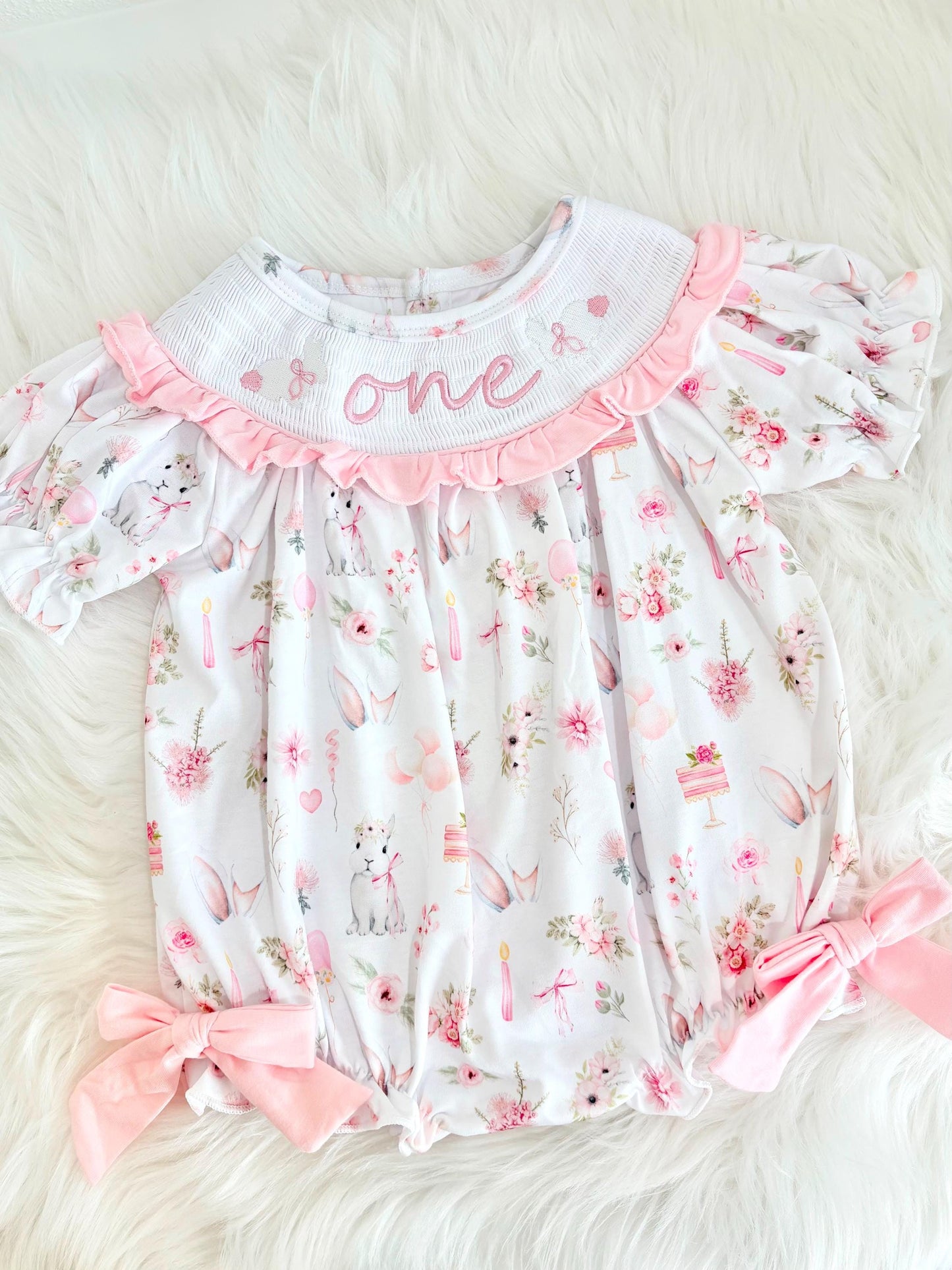 some bunny is one  pink bow first birthday girl romper pink and white outfit, girls one pink white smocked romper dress first birthday spring bunny rabbit easter bow ruffle embroidered smocked short sleeve 1st birthday outfit romper baby girls, the mod mango baby boutique co