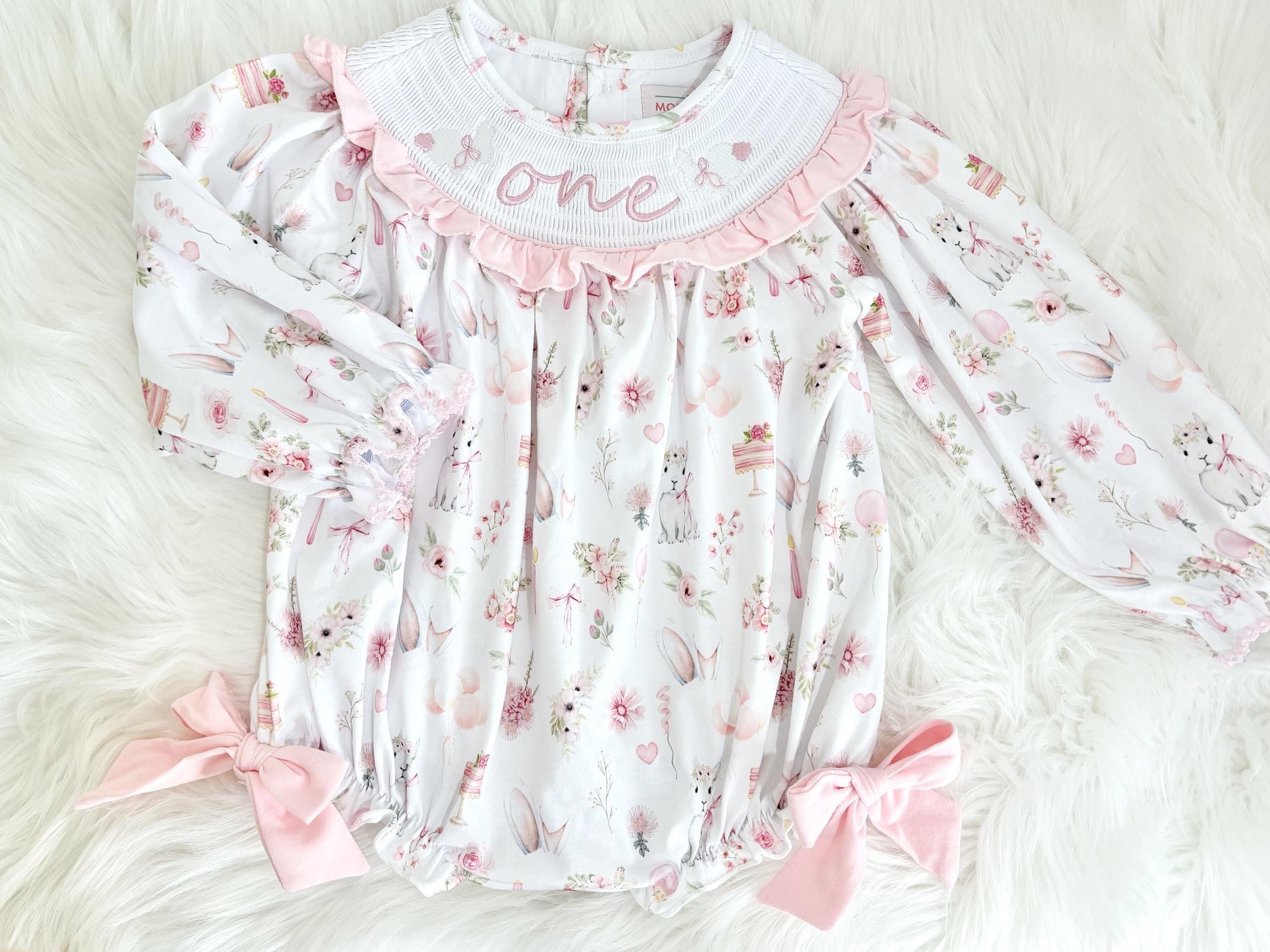 some bunny is one  pink bow first birthday girl romper pink and white outfit, girls one pink white smocked romper dress first birthday spring bunny rabbit easter bow ruffle embroidered smocked short sleeve 1st birthday outfit romper baby girls, the mod mango baby boutique co