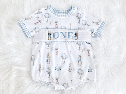 peter rabbit shirt first birthday boy romper spring baby blue and white gingham checkered tan beige outfit, ONE smocked bubble romper first birthday bunny rabbit, some bunny is one embroidered smocked 1st birthday outfit romper baby boys easter, the mod mango baby boutique co