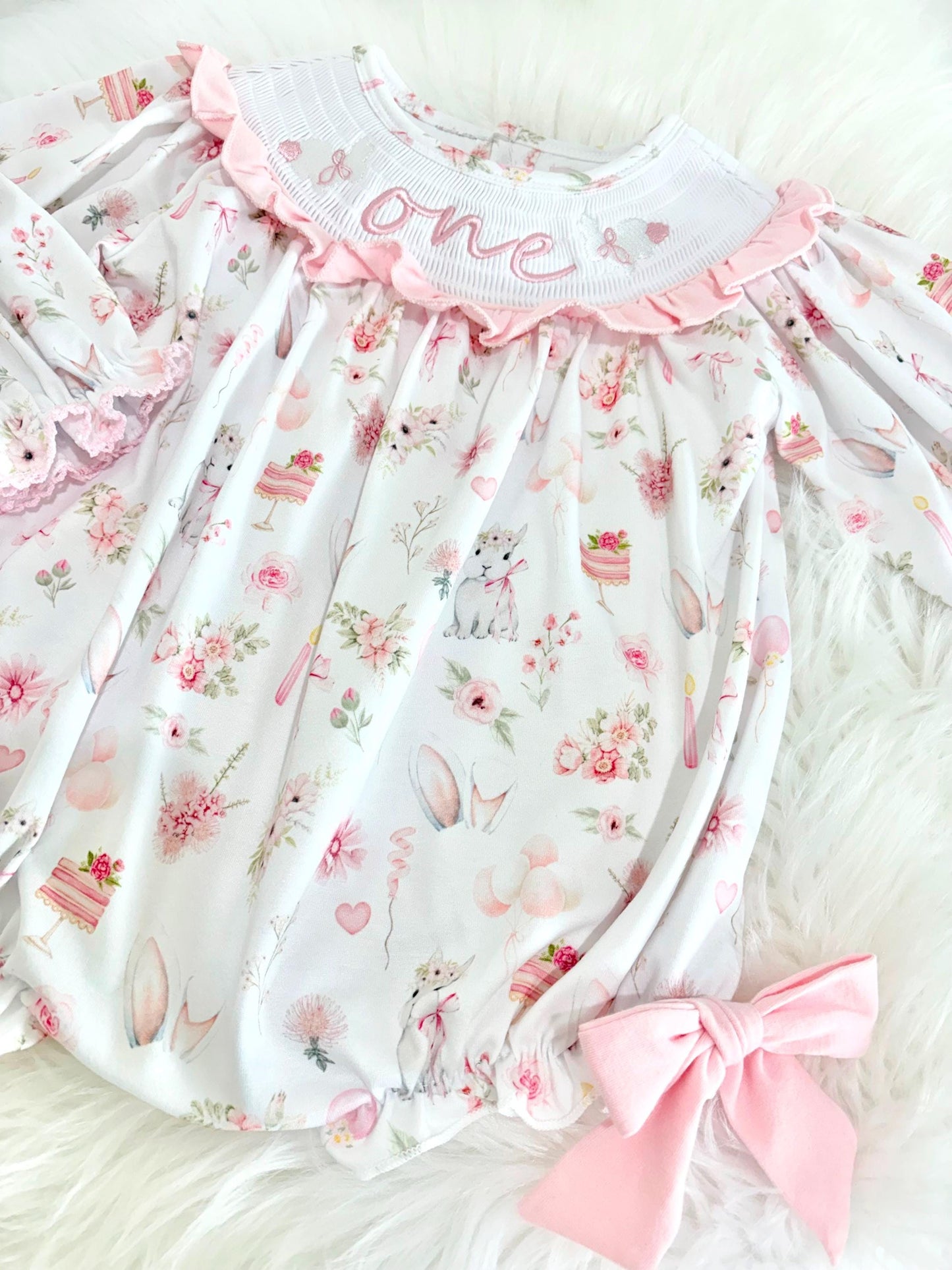 some bunny is one  pink bow first birthday girl romper pink and white outfit, girls one pink white smocked romper dress first birthday spring bunny rabbit easter bow ruffle embroidered smocked short sleeve 1st birthday outfit romper baby girls, the mod mango baby boutique co