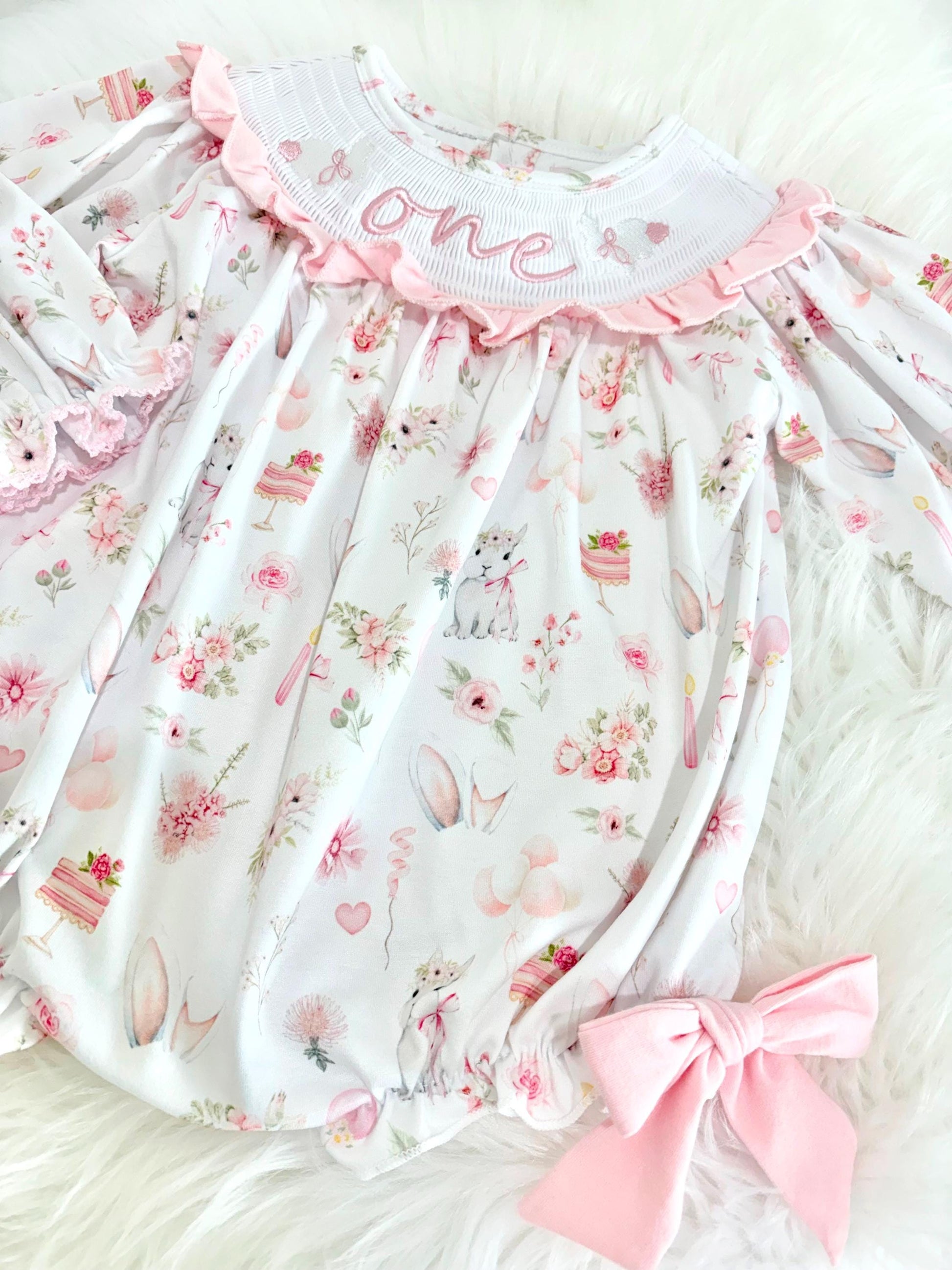 some bunny is one  pink bow first birthday girl romper pink and white outfit, girls one pink white smocked romper dress first birthday spring bunny rabbit easter bow ruffle embroidered smocked short sleeve 1st birthday outfit romper baby girls, the mod mango baby boutique co