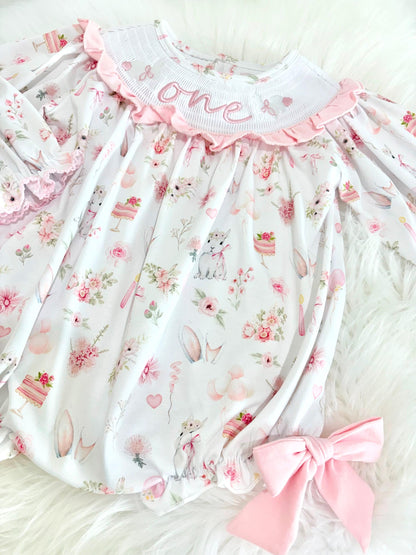 some bunny is one  pink bow first birthday girl romper pink and white outfit, girls one pink white smocked romper dress first birthday spring bunny rabbit easter bow ruffle embroidered smocked short sleeve 1st birthday outfit romper baby girls, the mod mango baby boutique co