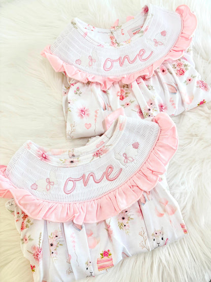 some bunny is one  pink bow first birthday girl romper pink and white outfit, girls one pink white smocked romper dress first birthday spring bunny rabbit easter bow ruffle embroidered smocked short sleeve 1st birthday outfit romper baby girls, the mod mango baby boutique co