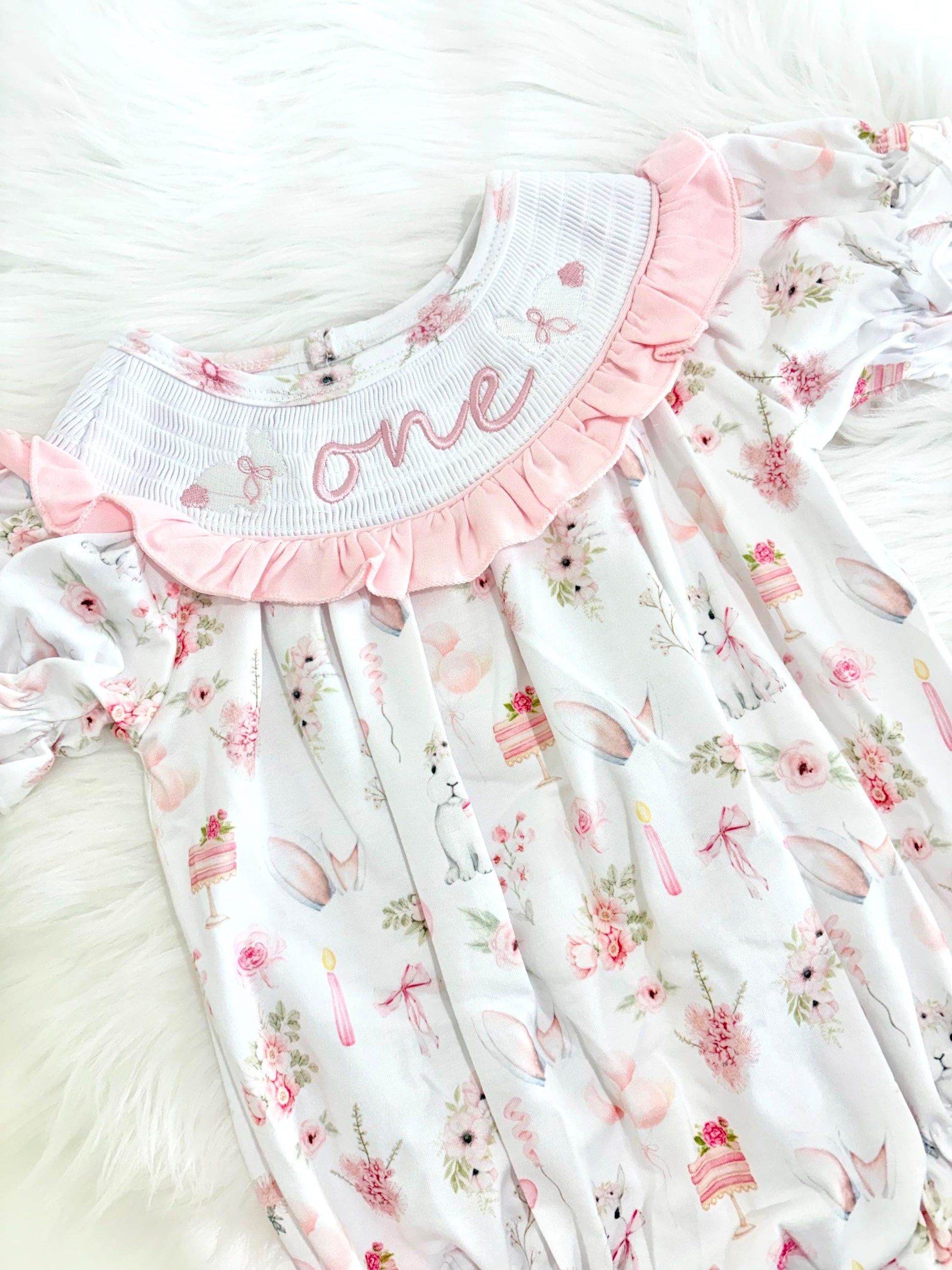 some bunny is one  pink bow first birthday girl romper pink and white outfit, girls one pink white smocked romper dress first birthday spring bunny rabbit easter bow ruffle embroidered smocked short sleeve 1st birthday outfit romper baby girls, the mod mango baby boutique co