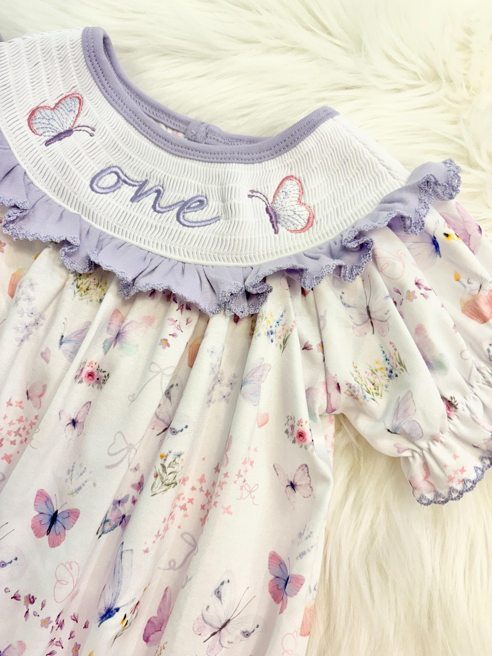 lavender purple butterfly flowers bows first birthday girl romper pink pastel floral and white outfit, pink lavender and white smocked bubble romper butterflies first birthday one year fluttered by ruffle bows embroidered smocked 1st birthday outfit romper baby girls, the mod mango, the mod mango baby co baby boutique