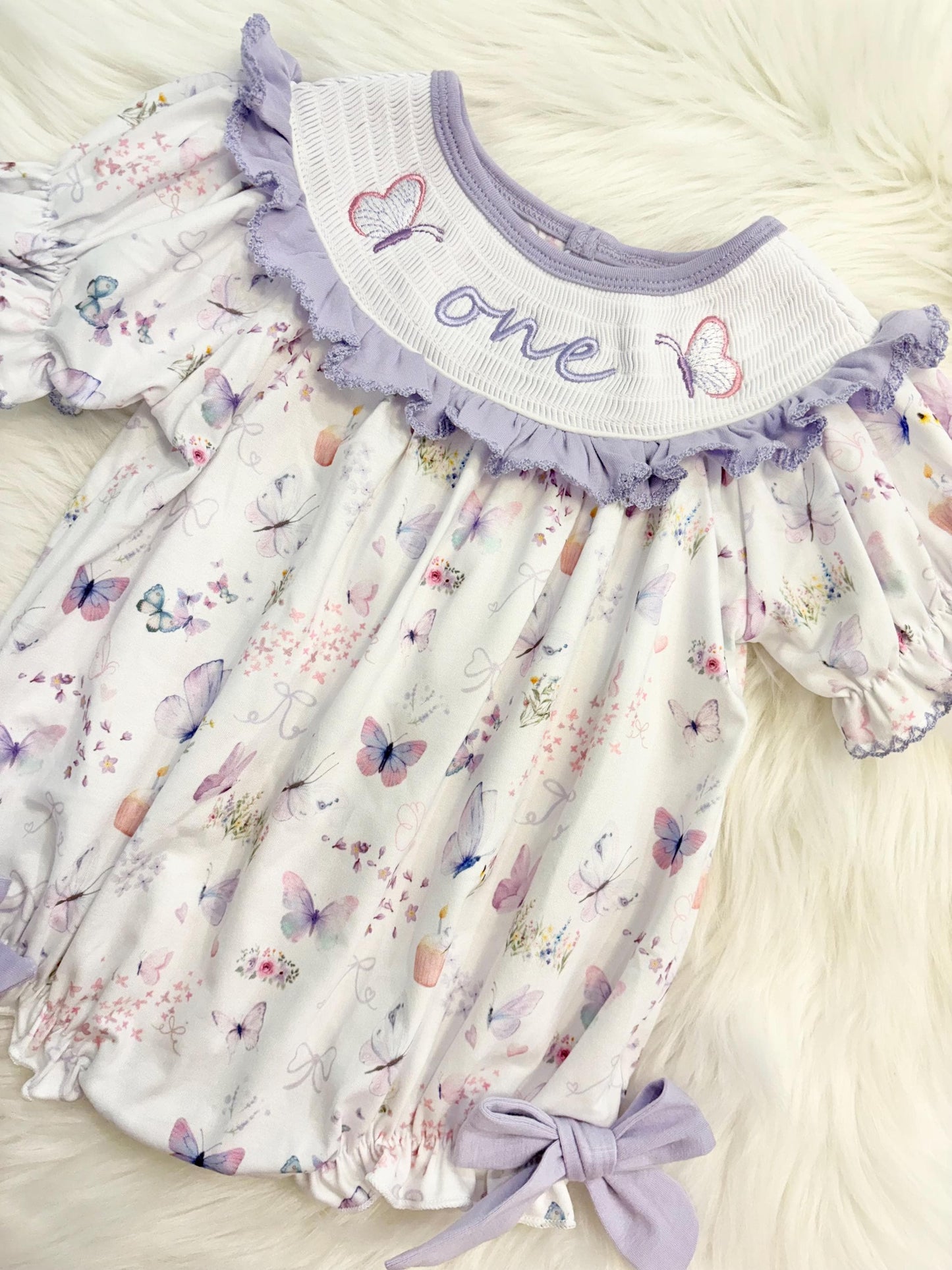 lavender purple butterfly flowers bows first birthday girl romper pink pastel floral and white outfit, pink lavender and white smocked bubble romper butterflies first birthday one year fluttered by ruffle bows embroidered smocked 1st birthday outfit romper baby girls, the mod mango, the mod mango baby co baby boutique