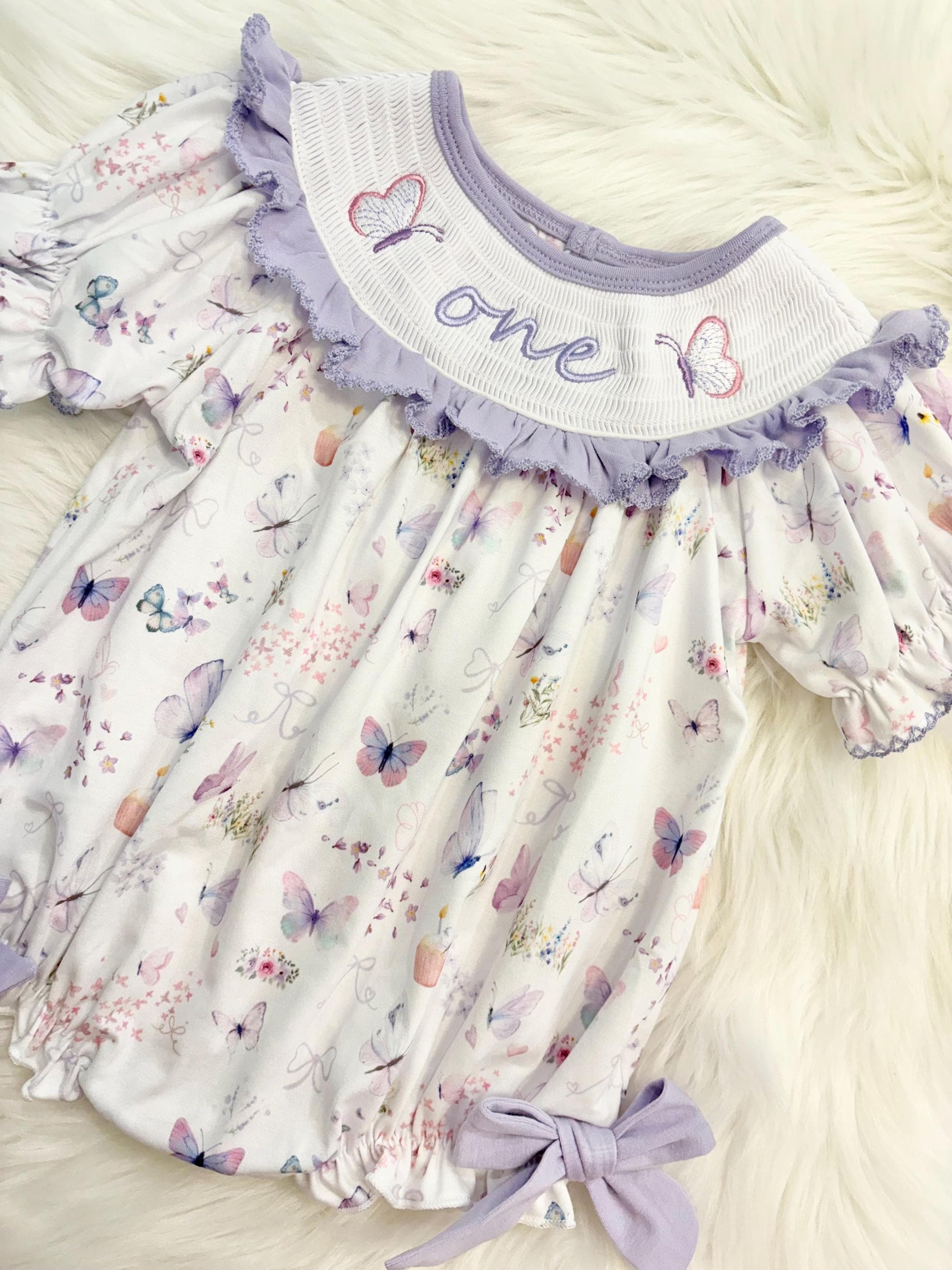 lavender purple butterfly flowers bows first birthday girl romper pink pastel floral and white outfit, pink lavender and white smocked bubble romper butterflies first birthday one year fluttered by ruffle bows embroidered smocked 1st birthday outfit romper baby girls, the mod mango, the mod mango baby co baby boutique