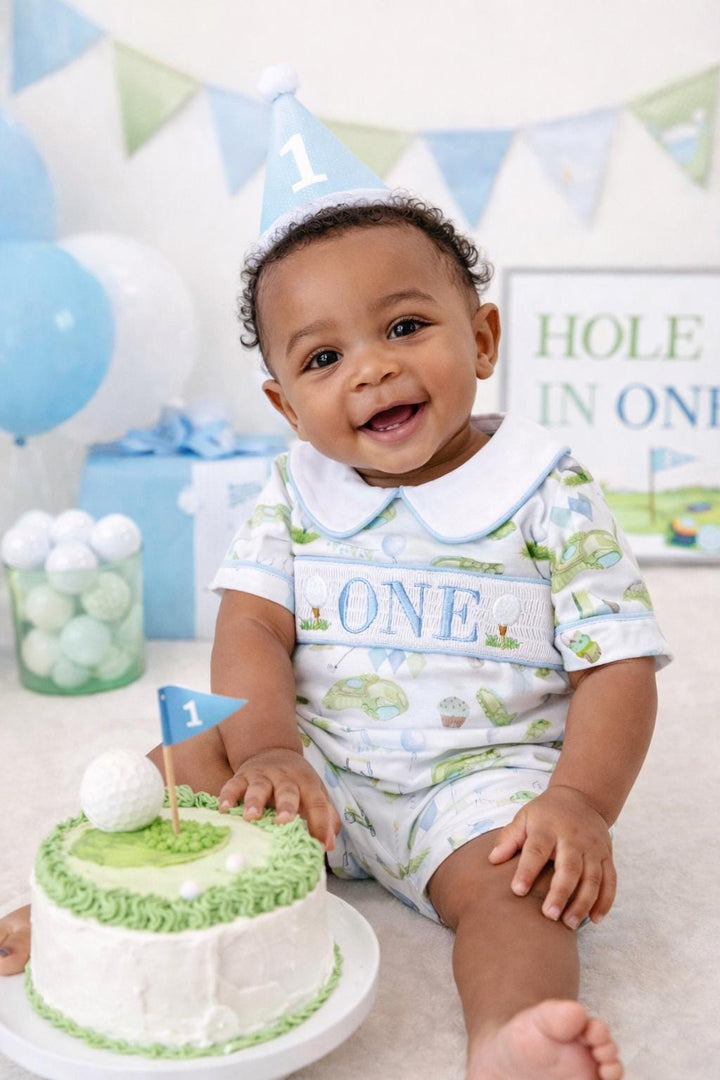 hole in one golf outfit shirt first birthday boy romper spring baby blue and white argyle blue green outfit, ONE smocked romper first birthday par tee, golfing golf balls embroidered smocked 1st birthday outfit romper baby boys, the mod mango baby boutique co