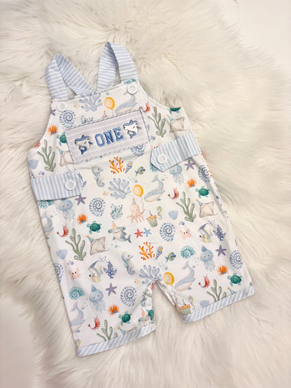 oneder the sea cake smash outfit first birthday boy romper under the sea ocean summer baby blue green white orange blue smash cake outfit overalls, ONE smocked romper first birthday sea ocean creatures party fish, beach ocean shark whale seashells octopus outdoors embroidered smocked spring summer 1st birthday boy outfit romper baby boys cake smash outfit, the mod mango baby boutique co