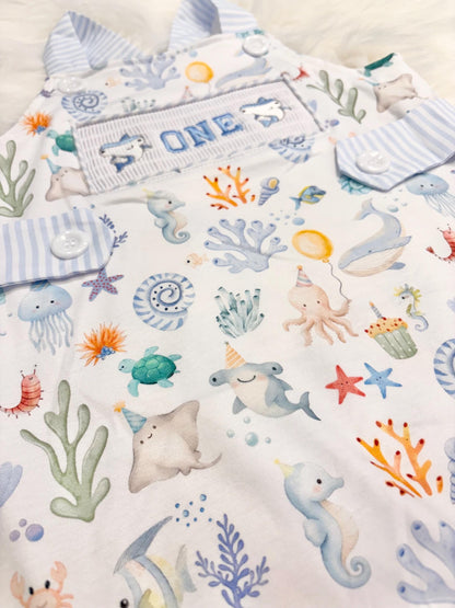 oneder the sea cake smash outfit first birthday boy romper under the sea ocean summer baby blue green white orange blue smash cake outfit overalls, ONE smocked romper first birthday sea ocean creatures party fish, beach ocean shark whale seashells octopus outdoors embroidered smocked spring summer 1st birthday boy outfit romper baby boys cake smash outfit, the mod mango baby boutique co