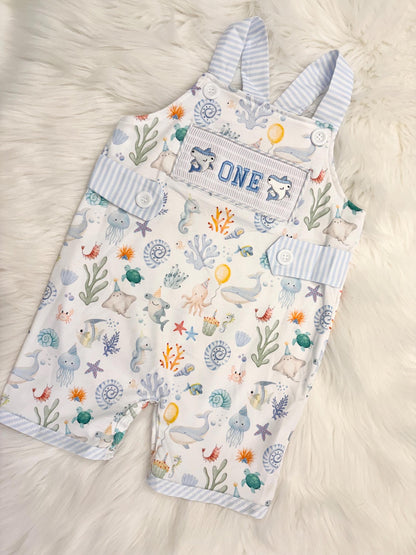 oneder the sea cake smash outfit first birthday boy romper under the sea ocean summer baby blue green white orange blue smash cake outfit overalls, ONE smocked romper first birthday sea ocean creatures party fish, beach ocean shark whale seashells octopus outdoors embroidered smocked spring summer 1st birthday boy outfit romper baby boys cake smash outfit, the mod mango baby boutique co