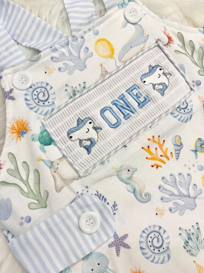 oneder the sea cake smash outfit first birthday boy romper under the sea ocean summer baby blue green white orange blue smash cake outfit overalls, ONE smocked romper first birthday sea ocean creatures party fish, beach ocean shark whale seashells octopus outdoors embroidered smocked spring summer 1st birthday boy outfit romper baby boys cake smash outfit, the mod mango baby boutique co