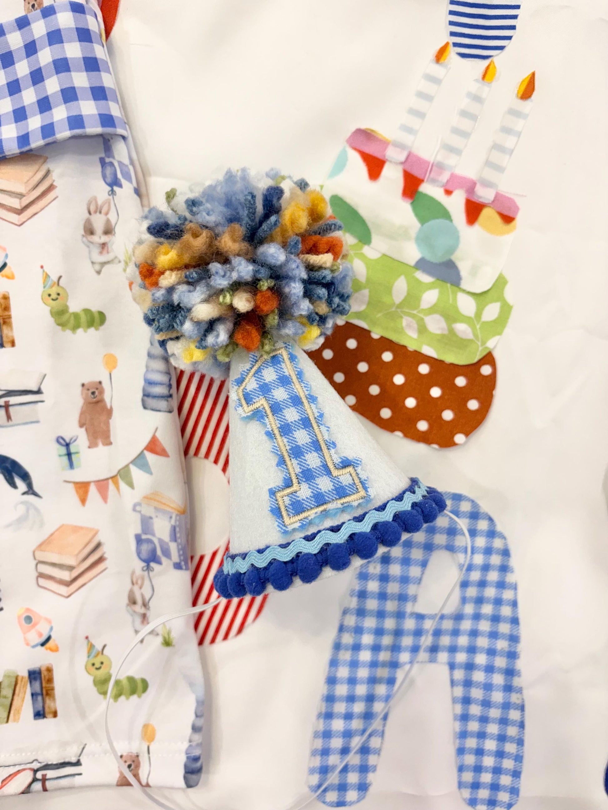 mini first birthday hat, chapter one books birthday boy romper one for the books shortalls blue white gingham smash cake outfit overalls, ONE smocked romper first birthday books, storybooks baby goose embroidered smocked spring summer fall 1st birthday boy outfit romper baby boys reading 1st birthday, the mod mango baby co