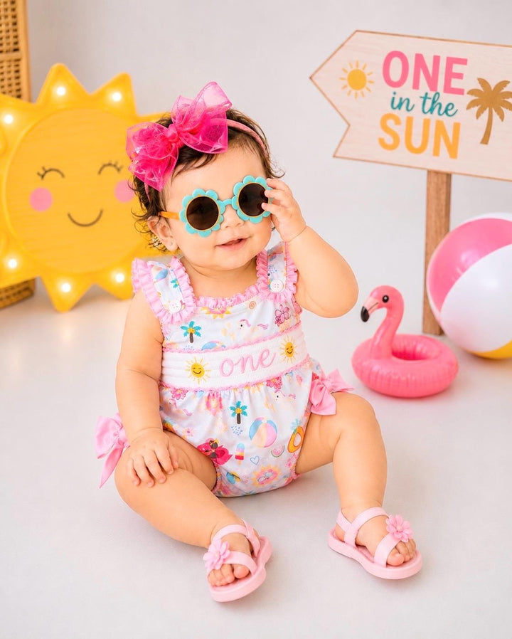 one in the sun first birthday outfit bubble romper hot pink pool party and bows first birthday girl romper pink ruffle beach baby outfit, girls sunshine sun smocked bubble romper first birthday summer bows ruffle embroidered smocked beach ball floaties 1st birthday outfit romper baby girl cake smash outfit summertime, pink turquoise yellow pineapple, the mod mango baby boutique co