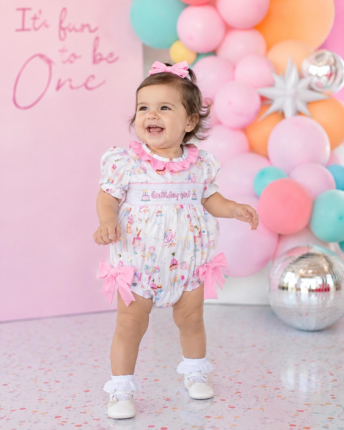 one is fun first birthday outfit, pink first birthday smocked bubble romper outfit its fun to be one pink bow ruffle first birthday girl romper pink and white outfit, colorful rainbow pink white smocked bubble romper first birthday winter bows ruffle bows  embroidered smocked long sleeve 1st birthday outfit romper baby girls, the mod mango baby boutique co
