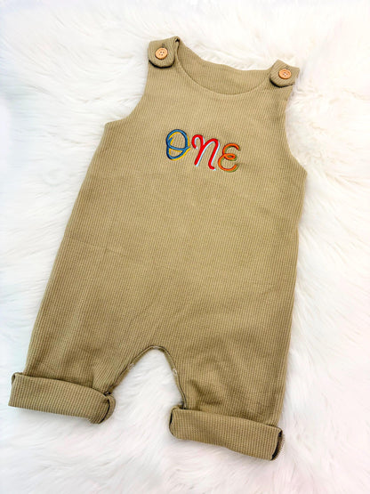 colorful green fun to be one waffle knit baby boys first birthday one romper overalls jon jons olive green, blue, yellow, red, orange, first birthday theme boys romper first birthday overalls outfit one boys first birthday outfit, the mod mango baby boutique co